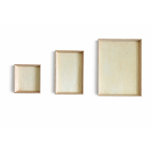 Three eco-friendly disposable wood charcuterie boards of different sizes on a white background
